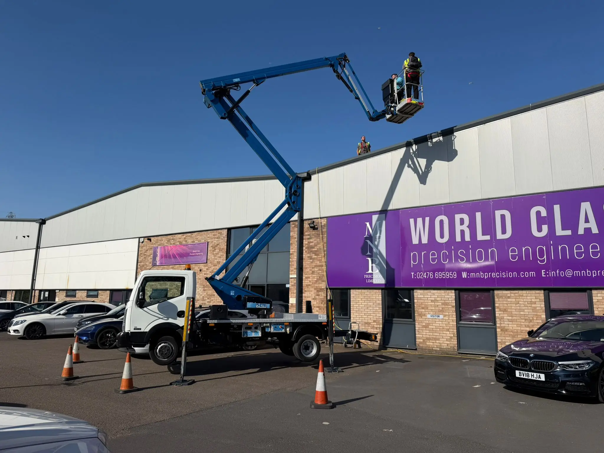 CTE Zed 21J 21m truck-mounted cherry picker deployed on a British high street with outriggers extended