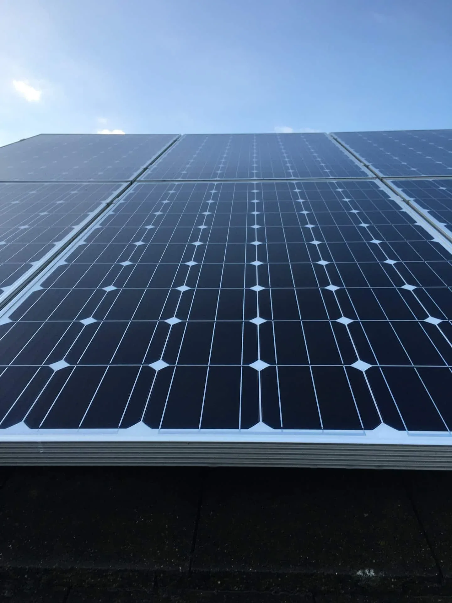 Professional solar panel cleaning on a residential roof